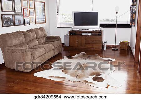 Picture - Television and a sofa in a living room. Fotosearch