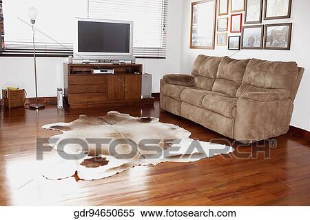 Television and a sofa in a living room View Large Photo Image Stock Photography - Television and a sofa in a living room. Fotosearch
