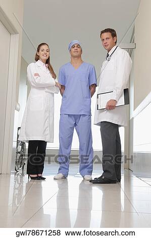 Three doctors standing together View Large Photo Image Stock Photo - Three doctors standing together. Fotosearch