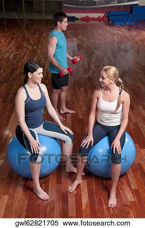 Three people exercising in a gym View Large Photo Image Stock Photography - Three people exercising in a gym. Fotosearch