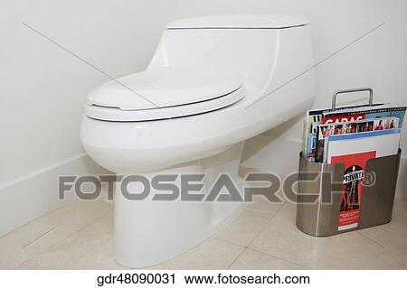 Toilet bowl with magazines in the bathroom View Large Photo Image Stock Image - Toilet bowl with magazines in the bathroom. Fotosearch