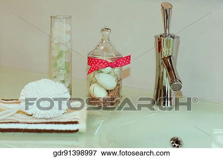 Toiletries on a bathroom sink View Large Photo Image Stock Photo - Toiletries on a bathroom sink. Fotosearch