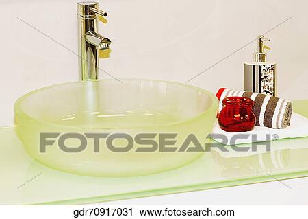 Towel and a soap dispenser on a bathroom sink View Large Photo Image Stock Image - Towel and a soap dispenser on a bathroom sink. Fotosearch