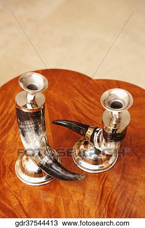 Stock Image - Two candlestick holders on a table. Fotosearch