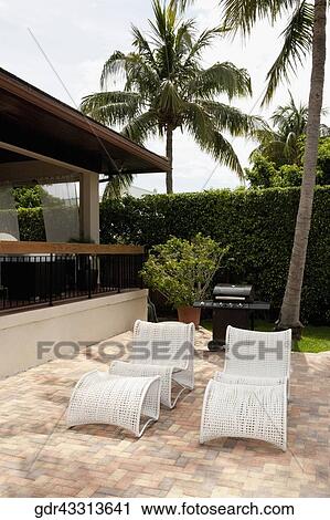 Two chairs in front of a house View Large Photo Image Stock Image - Two chairs in front of a house. Fotosearch