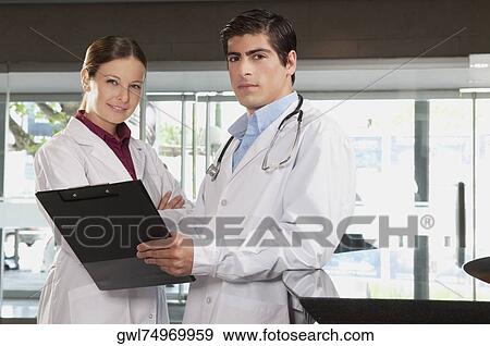 Two doctors with a clipboard View Large Photo Image Stock Photo - Two doctors with a clipboard. Fotosearch