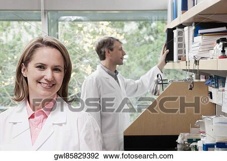 Two doctors working in a laboratory View Large Photo Image Stock Image - Two doctors working in a laboratory. Fotosearch
