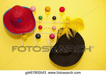 Two hats hanging on a coat hook View Large Photo Image Stock Image - Two hats hanging on a coat hook. Fotosearch