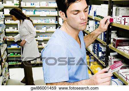 Two pharmacists in a pharmacy View Large Photo Image Stock Photo - Two pharmacists in a pharmacy. Fotosearch