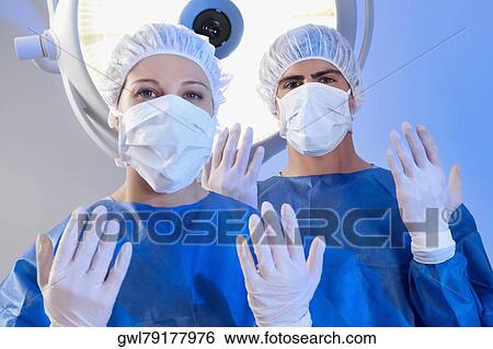 Two surgeons in an operating room View Large Photo Image Stock Photograph - Two surgeons in an operating room. Fotosearch
