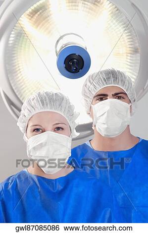 Stock Photograph - Two surgeons in an operating room. Fotosearch