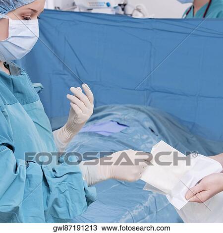 Two surgeons performing a surgery in an operating room View Large Photo Image Stock Image - Two surgeons performing a surgery in an operating room. Fotosearch