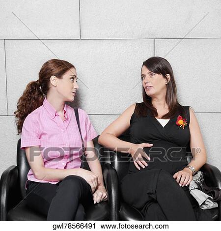 Two women sitting in a hospital waiting room View Large Photo Image Stock Image - Two women sitting in a hospital waiting room. Fotosearch