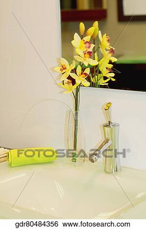 Vase of flowers on a bathroom sink View Large Photo Image Stock Photograph - Vase of flowers on a bathroom sink. Fotosearch