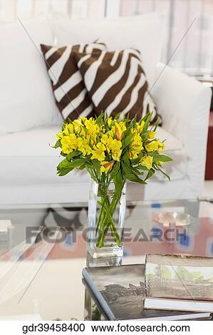 Vase of flowers on a table in a living room View Large Photo Image Stock Image - Vase of flowers on a table in a living room. Fotosearch