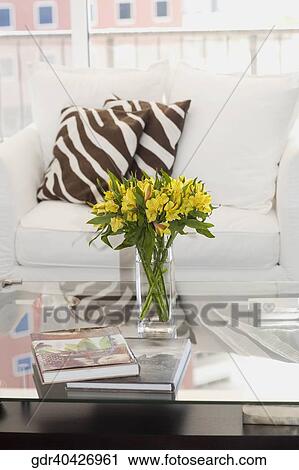 Vase of flowers on a table in a living room View Large Photo Image Stock Image - Vase of flowers on a table in a living room. Fotosearch