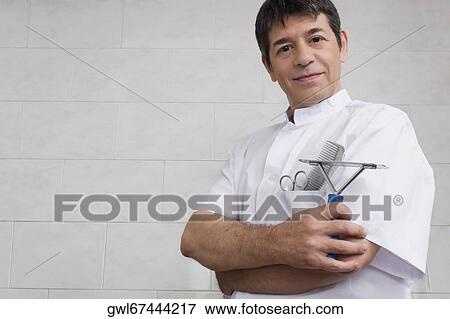 Vet holding a dog's comb View Large Photo Image Stock Photo - Vet holding a dog's comb. Fotosearch