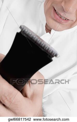 Vet holding an electric razor View Large Photo Image Stock Image - Vet holding an electric razor. Fotosearch