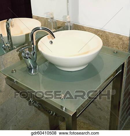 Wash bowl and a faucet in the bathroom View Large Photo Image Stock Photo - Wash bowl and a faucet in the bathroom. Fotosearch
