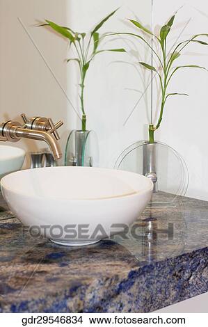 Picture - Wash bowl with a houseplant in the bathroom. Fotosearch