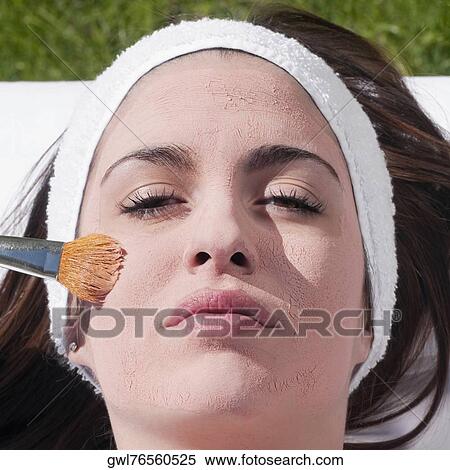 Woman applying a facial mask View Large Photo Image Stock Photography - Woman applying a facial mask. Fotosearch