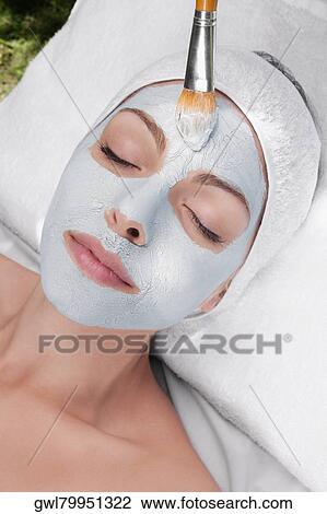 Stock Image - Woman applying face pack. Fotosearch