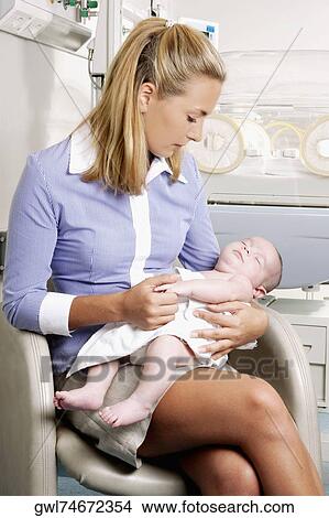 Woman carrying her newborn baby View Large Photo Image Picture - Woman carrying her newborn baby. Fotosearch
