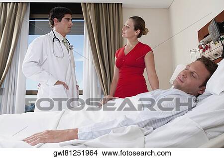 Woman discussing with a doctor View Large Photo Image Picture - Woman discussing with a doctor. Fotosearch
