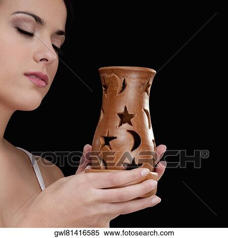 Woman holding an incense burner View Large Photo Image Stock Photography - Woman holding an incense burner. Fotosearch