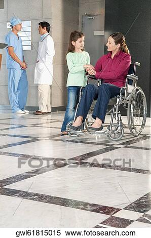 Stock Photography - Woman in a wheelchair with her daughter. Fotosearch