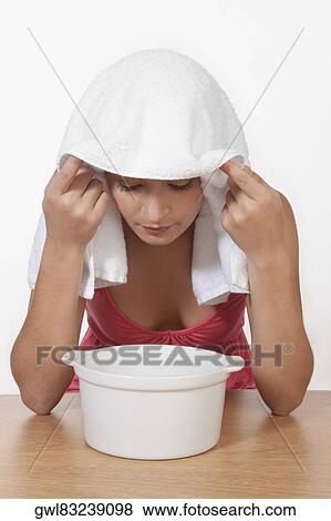 Woman inhaling steam View Large Photo Image Stock Photo - Woman inhaling steam. Fotosearch