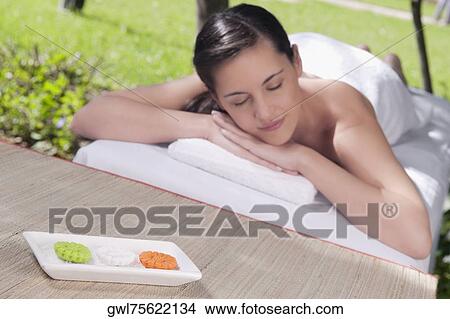 Woman lying on a massage table View Large Photo Image Picture - Woman lying on a massage table. Fotosearch