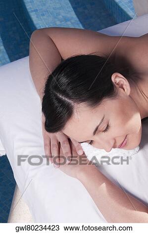 Woman lying on a massage table View Large Photo Image Stock Image - Woman lying on a massage table. Fotosearch