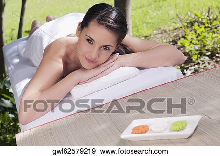 Woman lying on a massage table View Large Photo Image Stock Photo - Woman lying on a massage table. Fotosearch