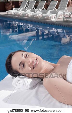 Woman lying on a massage table View Large Photo Image Stock Photo - Woman lying on a massage table. Fotosearch
