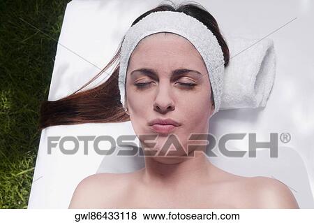 Stock Photo - Woman lying on a massage table. Fotosearch