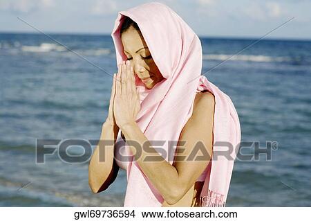 Picture - Woman meditating at the seaside. Fotosearch