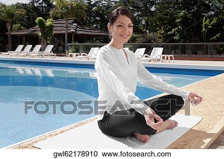 Woman practicing yoga at the poolside and smiling View Large Photo Image Stock Image - Woman practicing yoga at the poolside and smiling. Fotosearch