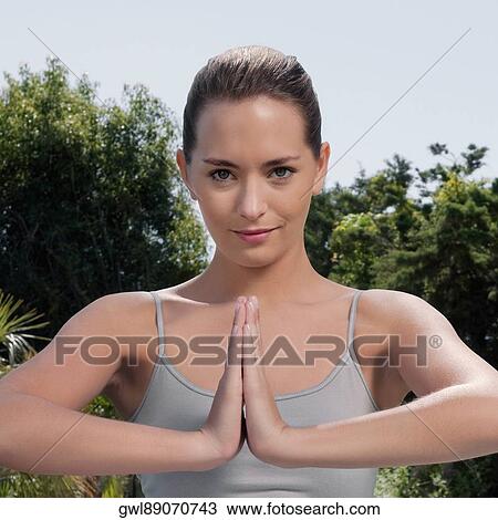 Woman practicing yoga in a park View Large Photo Image Stock Image - Woman practicing yoga in a park. Fotosearch