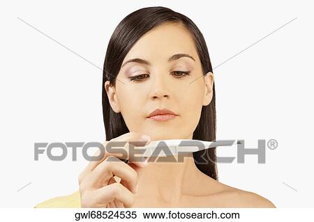 Woman reading a thermometer View Large Photo Image Stock Photography - Woman reading a thermometer. Fotosearch