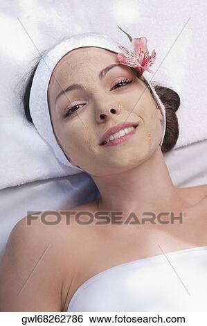Stock Photograph - Woman receiving facial treatment. Fotosearch