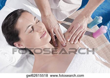 Woman receiving massage from a massage therapist View Large Photo Image Stock Photo - Woman receiving massage from a massage therapist. Fotosearch