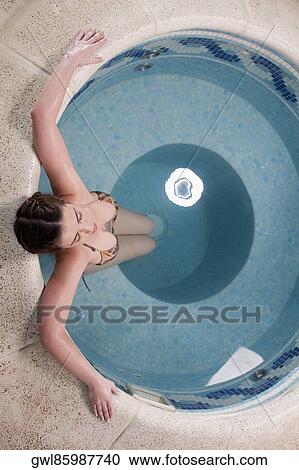 Woman relaxing in a hot tub View Large Photo Image Stock Image - Woman relaxing in a hot tub. Fotosearch