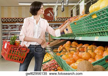 Woman shopping in a supermarket View Large Photo Image Stock Photography - Woman shopping in a supermarket. Fotosearch