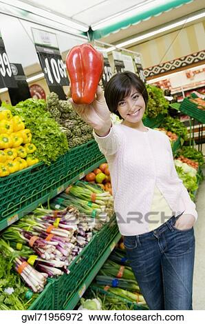 Woman shopping vegetables in a supermarket View Large Photo Image Stock Image - Woman shopping vegetables in a supermarket. Fotosearch
