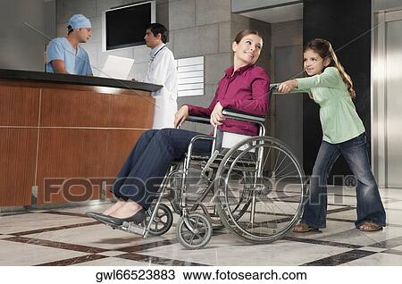 Woman sitting in a wheelchair being pushed by her daughter View Large Photo Image Stock Image - Woman sitting in a wheelchair being pushed by her daughter. Fotosearch