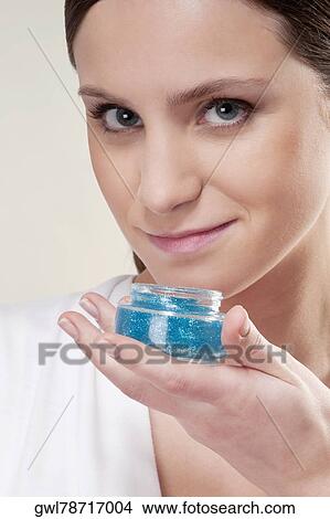 Picture - Woman smelling aroma gel. Fotosearch