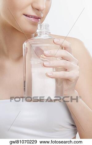 Woman smelling aromatherapy oil View Large Photo Image Stock Photo - Woman smelling aromatherapy oil. Fotosearch