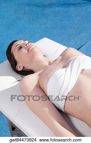 Woman sunbathing on a massage table View Large Photo Image Picture - Woman sunbathing on a massage table. Fotosearch
