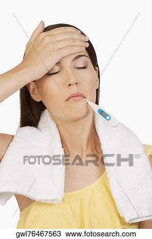 Woman taking her temperature View Large Photo Image Stock Image - Woman taking her temperature. Fotosearch